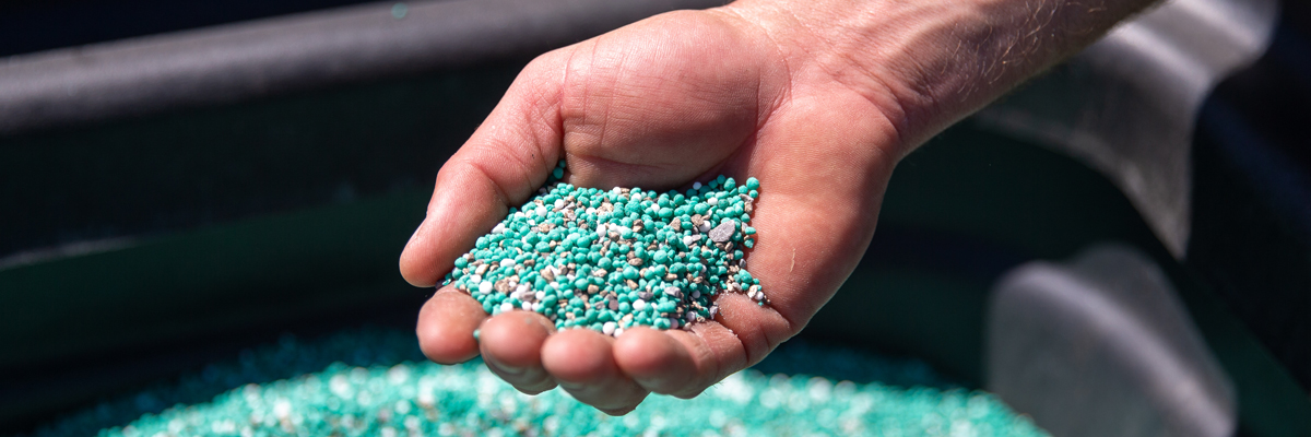 a hand grabbing POLYON controlled-release fertilizer